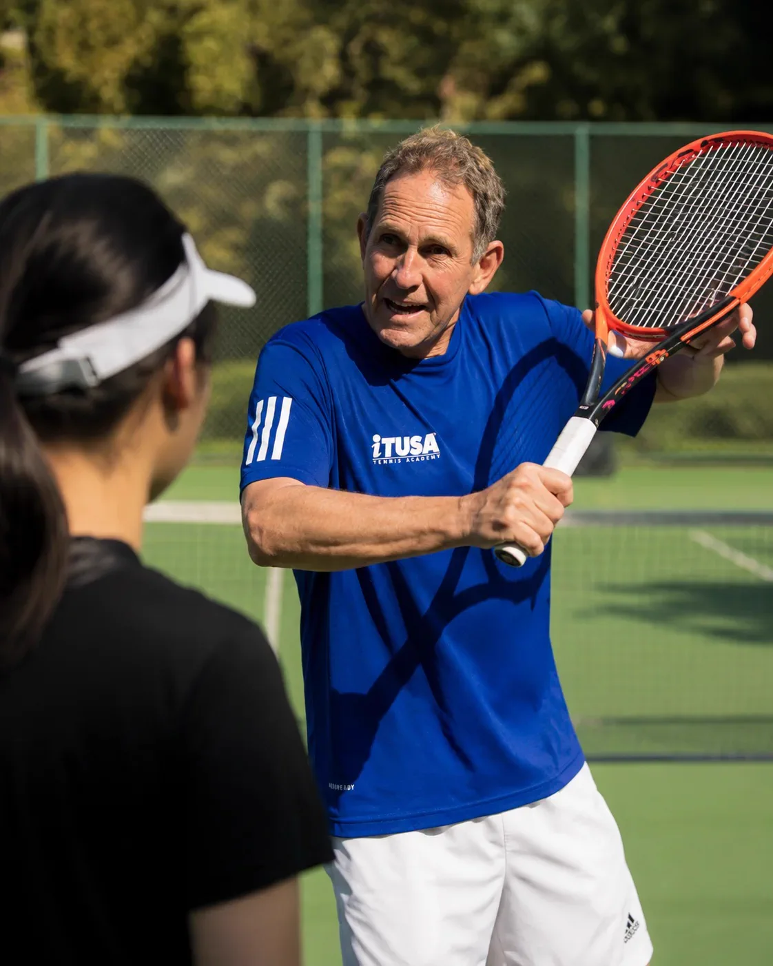 Rafael Font de Mora, iTUSA head coach, coaching a junior player on court